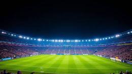 Italian football stadium at night under blue floodlights